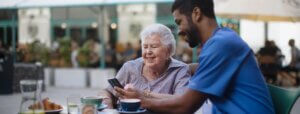 Elderly woman receiving in-home senior care from a professional caregiver.