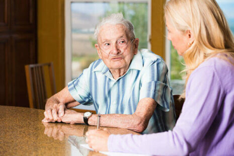 senior man with COPD talking to a caregiver