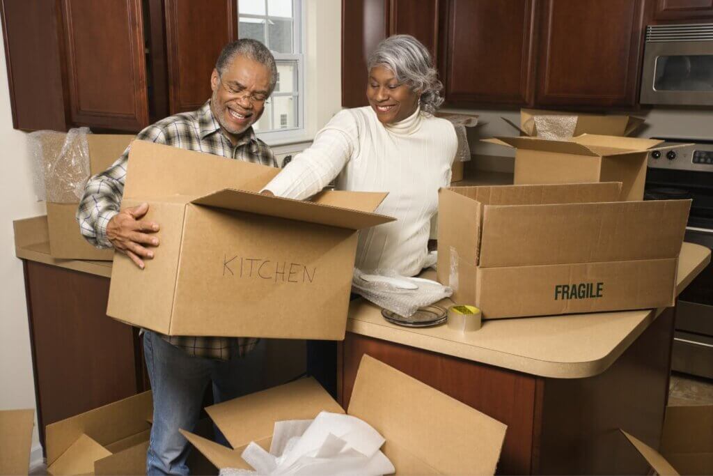An elderly couple is packing and preparing to move.