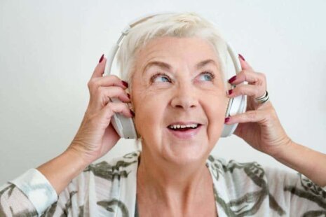 Elderly woman listening to music for Alzheimer's self-care