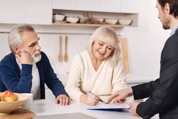 an elderly couple completes power of attorney paperwork