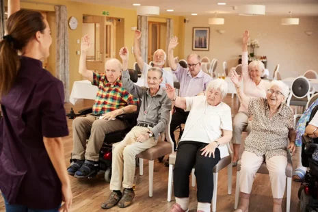 A group of seniors exercising at an adult day care center.