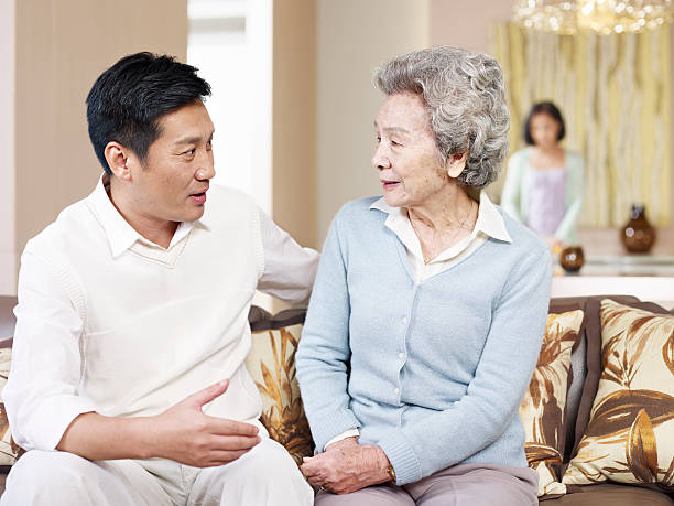 Elderly mother and son discussing elderly abuse and prevent it.