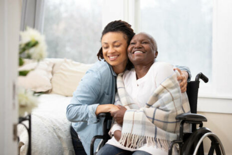 An elderly woman and her caregiver paid for by long term care insurance