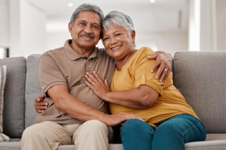 elderly couple on the couch happy they have long-term care insurance