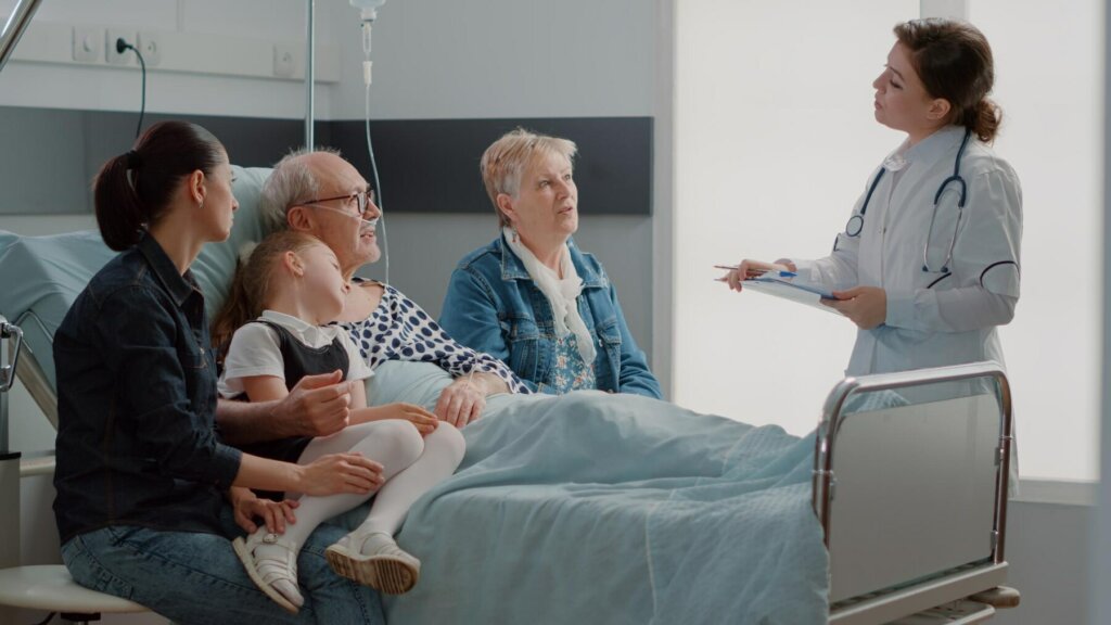Family speaking with a doctor during an elderly hospital stay.