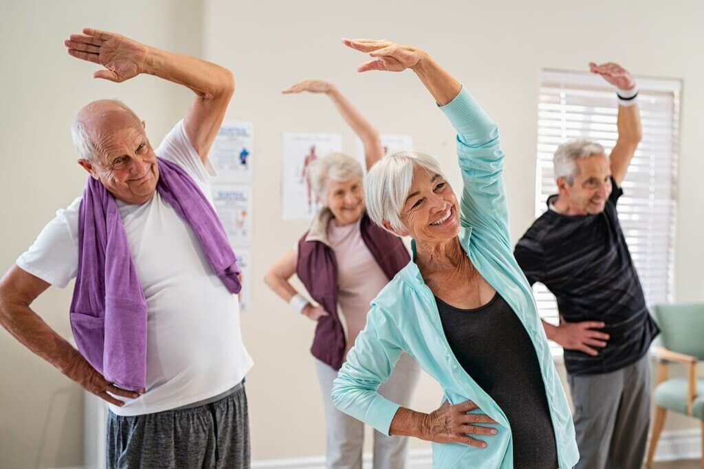 Seniors engaging in safe and beneficial indoor exercises for improved health and mobility.