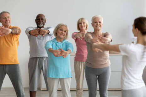 Elderly individuals engaging in physical exercise to promote health and wellness.