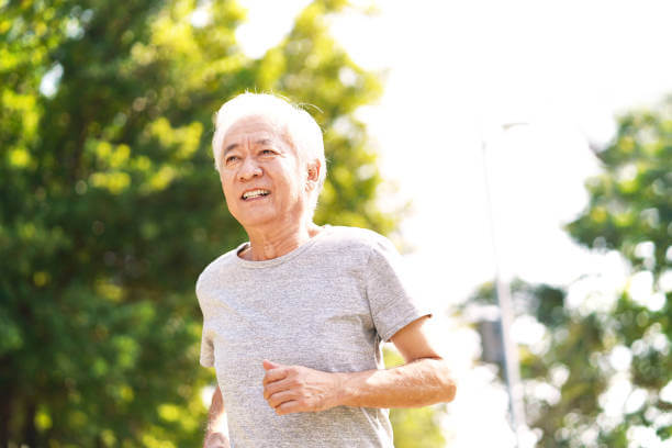 Senior asian man running outside to prevent vitamin D deficiency in the elderly.