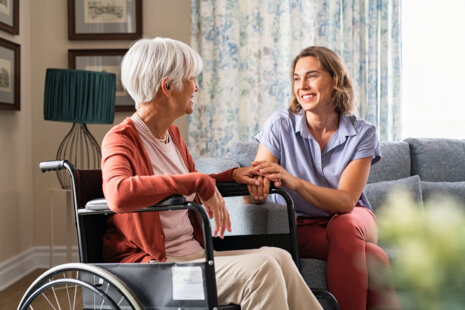 A compassionate caregiver providing 24-hour senior care to an elderly client.