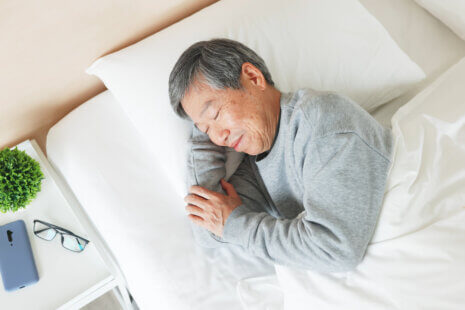 Senior man sleeping peacefully, following sleep tips for seniors