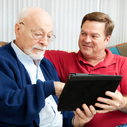 A man and his father discuss a reverse mortgage to pay for senior care.