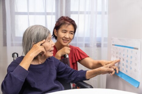 A caregiver engaging in transformative dementia care activities with an elderly individual, promoting well-being and connection.