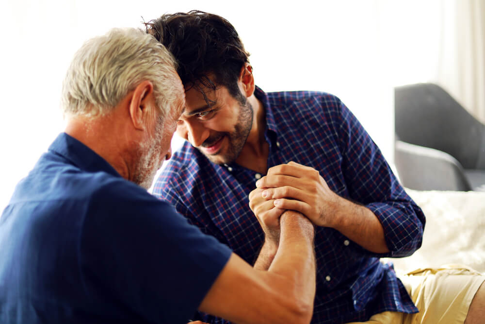 Father and son discussing signs it's time for senior care