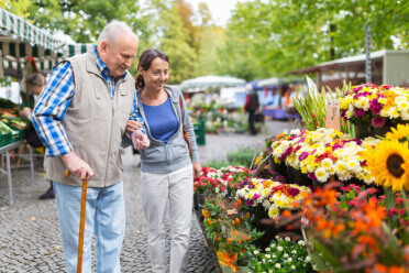 Man with daughter shopping for flowers