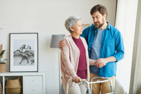 Senior woman using walker and talking to her son about elderly abuse.