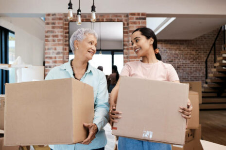 Daughter helping her elderly mother move.