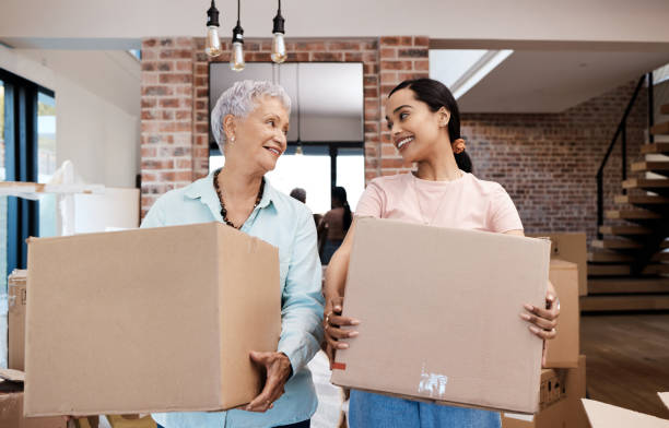 Daughter helping her elderly mother move.