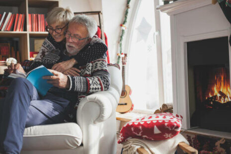 An elderly couple enjoying winter activities indoors.