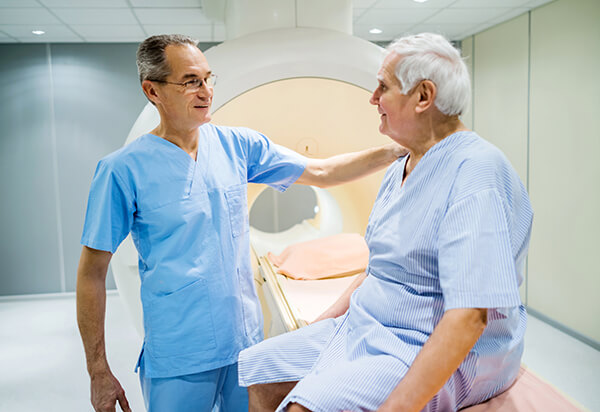 Mature radiologist talking to senior patient