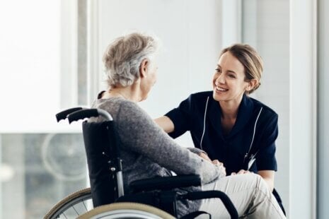 An elderly person and caregiver discussing stroke prevention and recovery strategies.