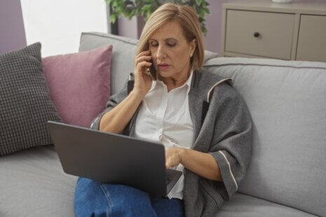 Daughter video calling her mother while managing long-distance caregiving for aging parents