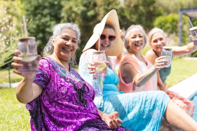 Seniors hydrating next to the pool, staying active with summer activities for seniors